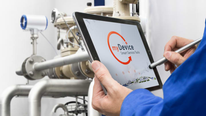Service technician using mydevice in front of an industrial plant