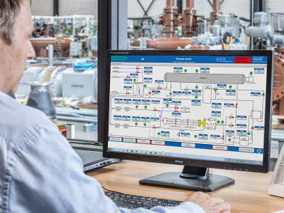 Engineer working with SynEnergy supervisory and visualisation software in a factory office