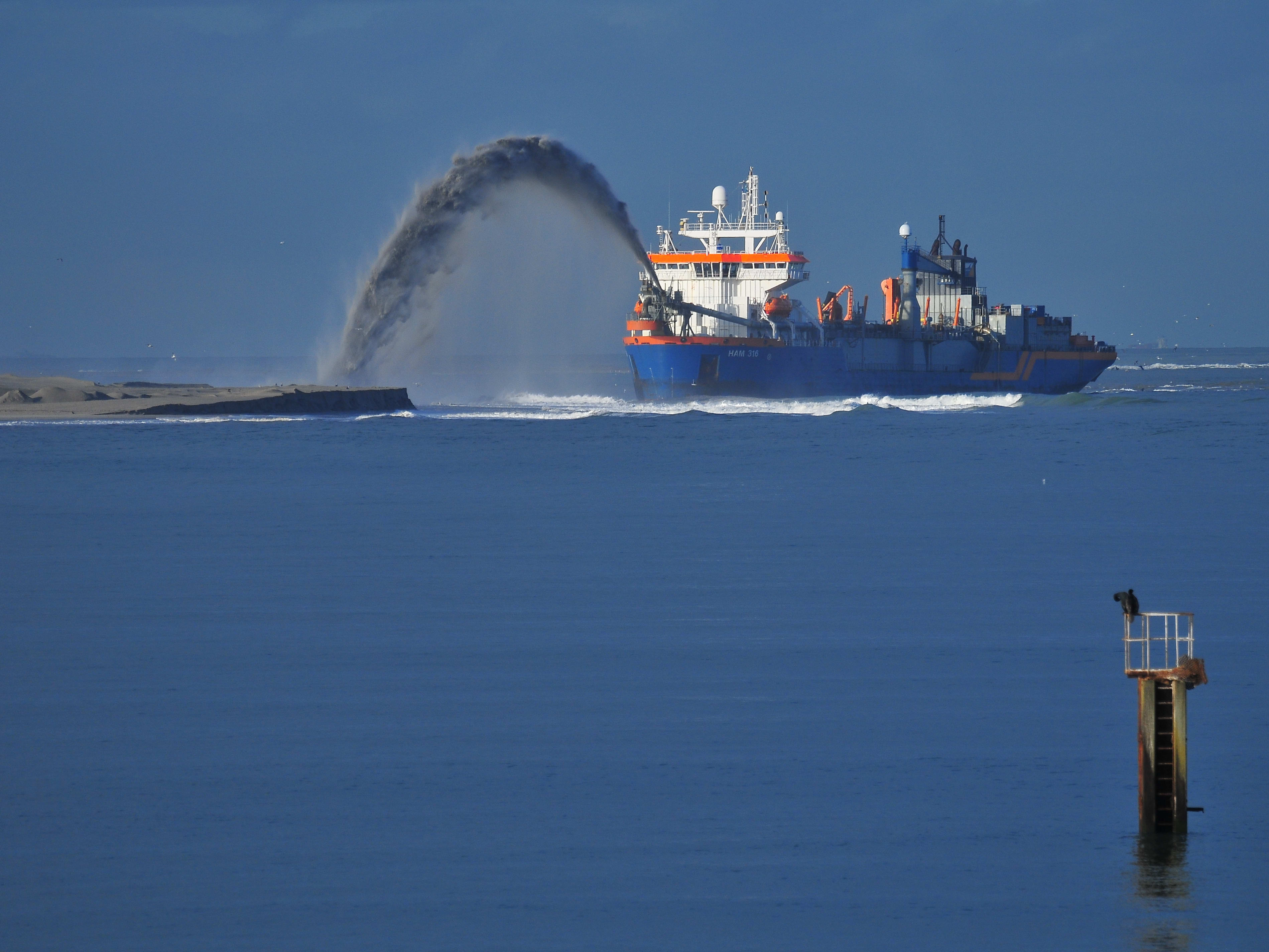 Dredgers in the marine industry Blue dredger discharding